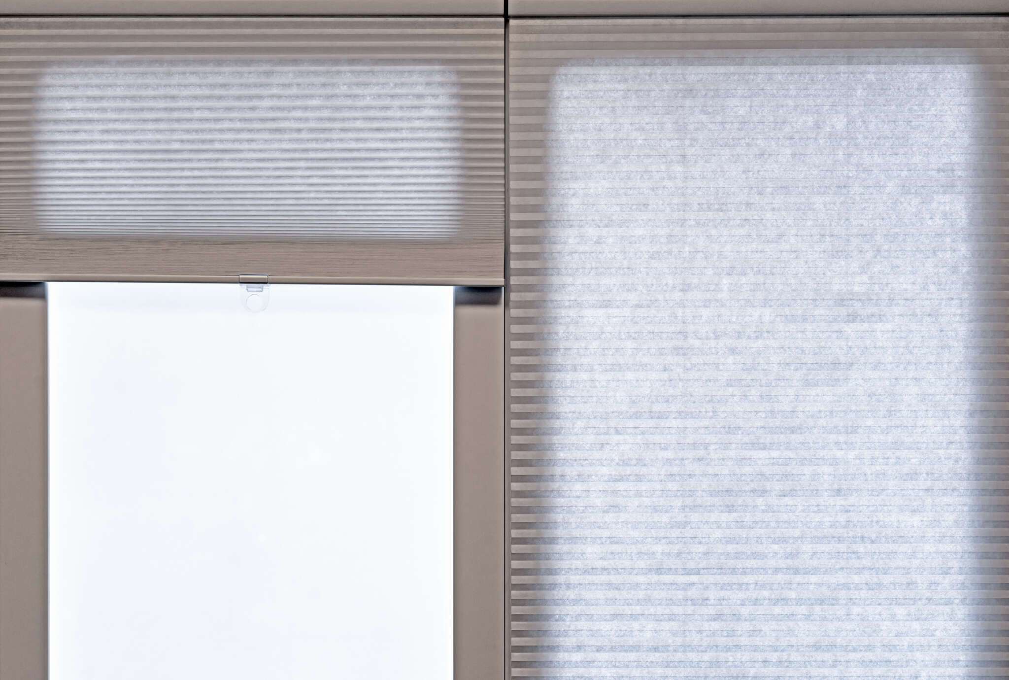 Beige corrugated blinds on the living room window.